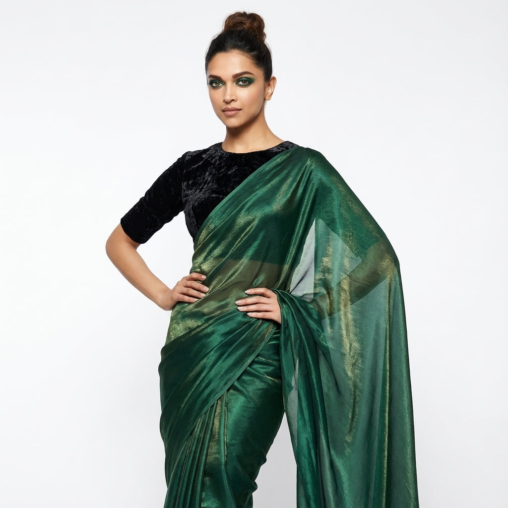 Bottle green fandy saree paired with velvet blouse for royal ethnic look