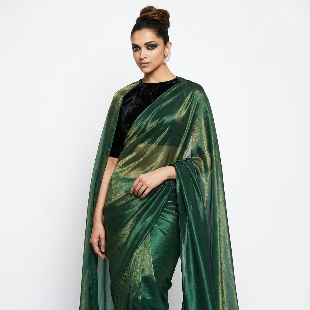 Bottle green fandy saree paired with velvet blouse for royal ethnic look