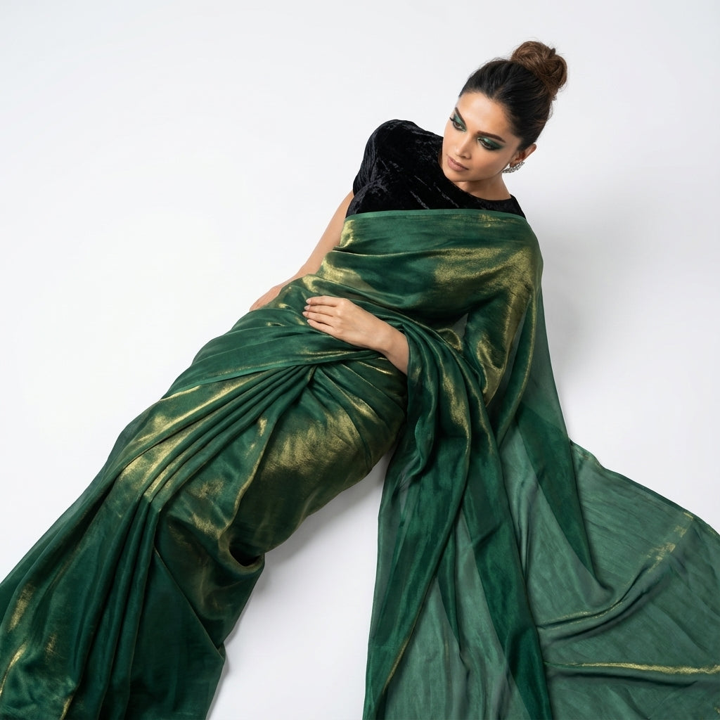 Bottle green fandy saree paired with velvet blouse for royal ethnic look